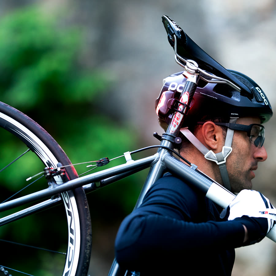 Rider carrying bike with Cliq taillight glowing